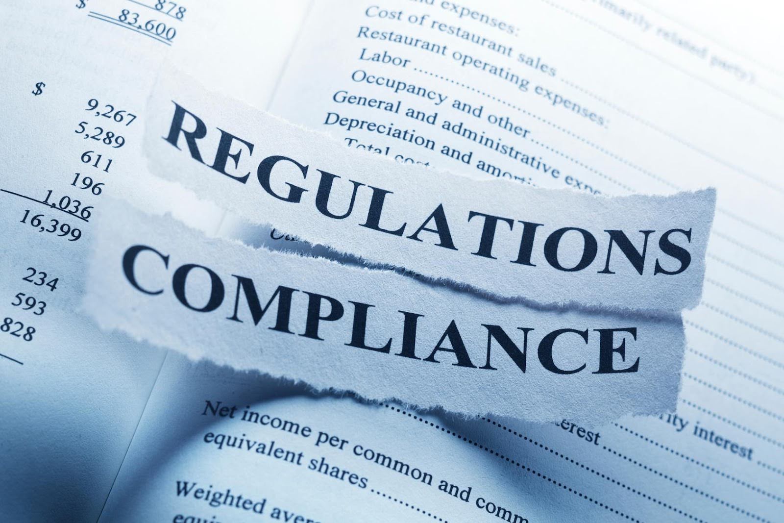 Torn paper with the words “Regulations” and “Compliance” symbolizing regulatory requirements and compliance for disability care providers.